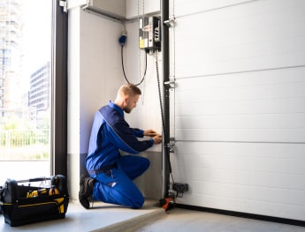 man repairing garage door